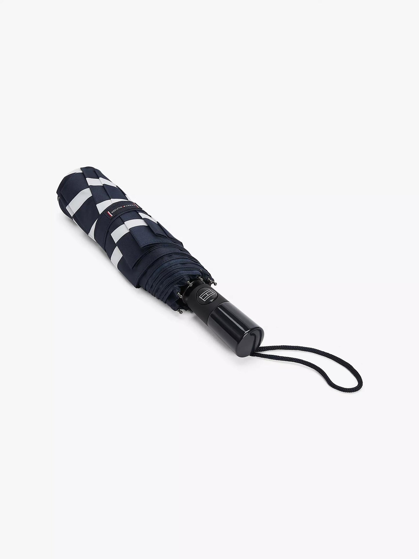 Sombrilla Tommy H azul marino con rayas blancas, mango negro y botones de abrir/cerrar