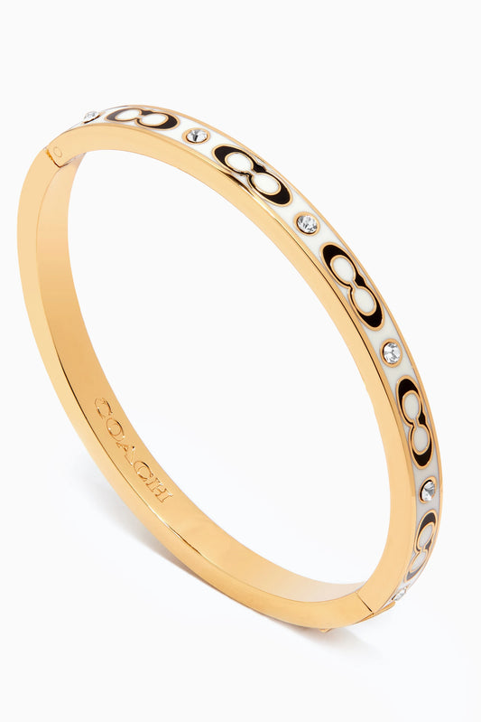 Brazalete Coach dorado/beige, letra negra