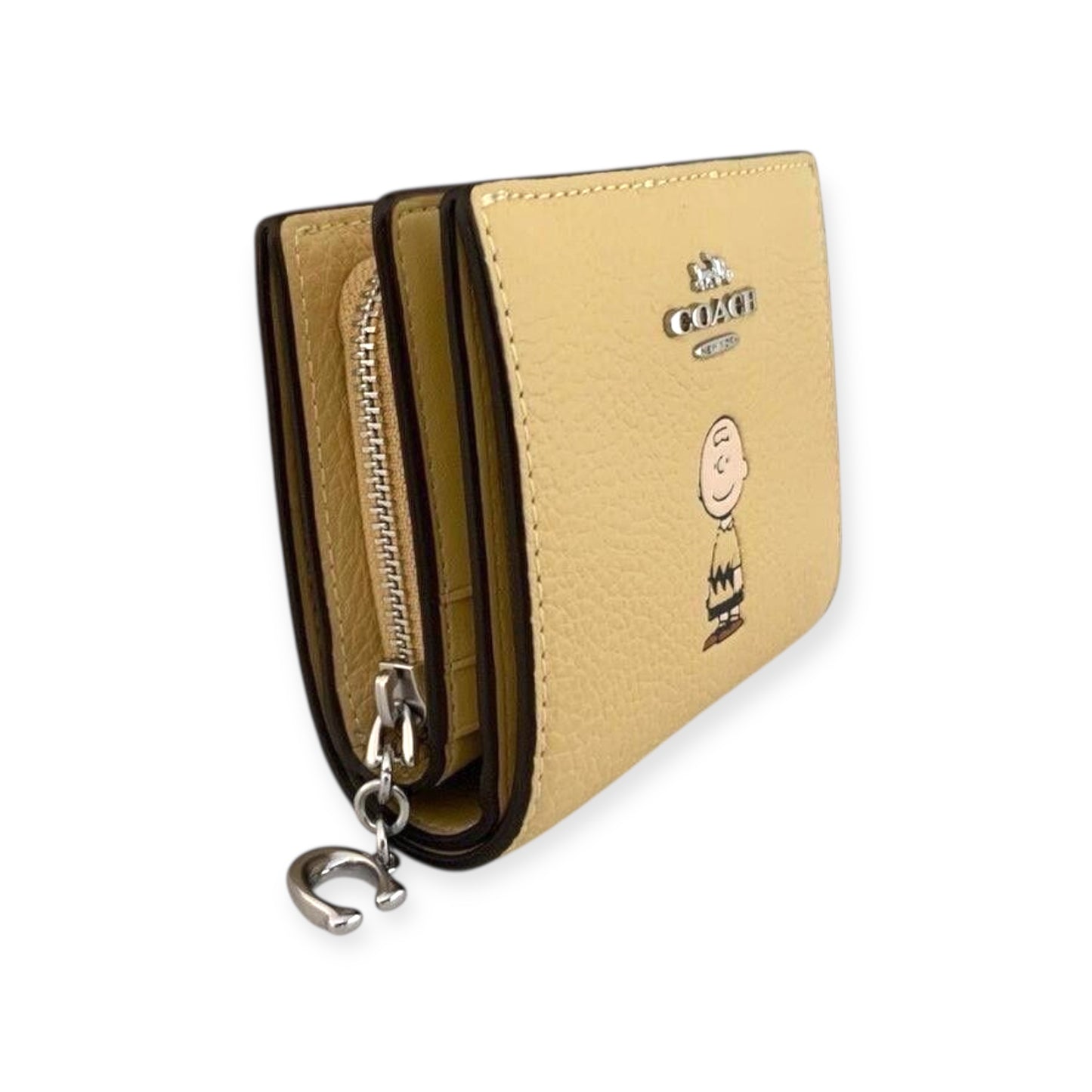 Cartera coach amarilla, Charly Brown