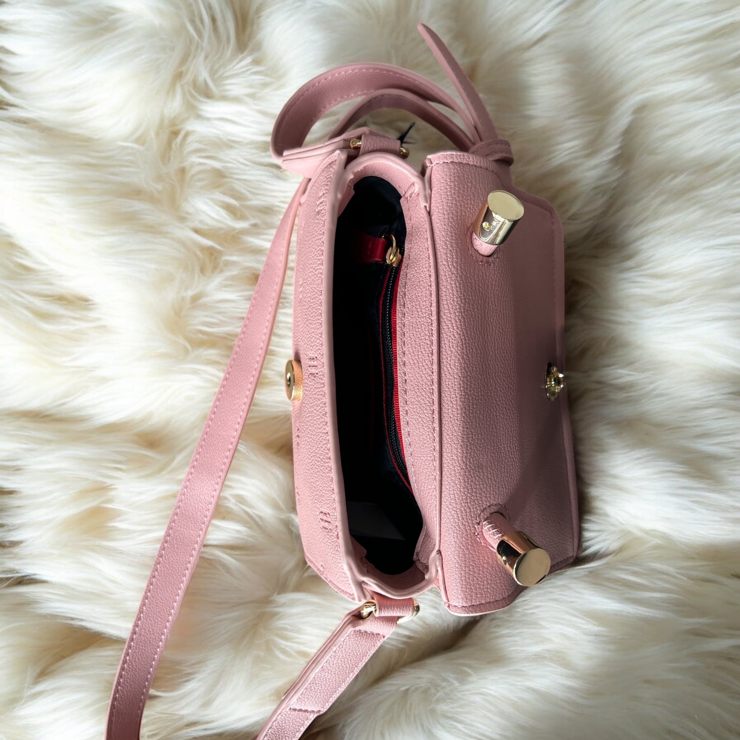 Crossbody Tommy H pequeña rosa claro y placa dorada TH