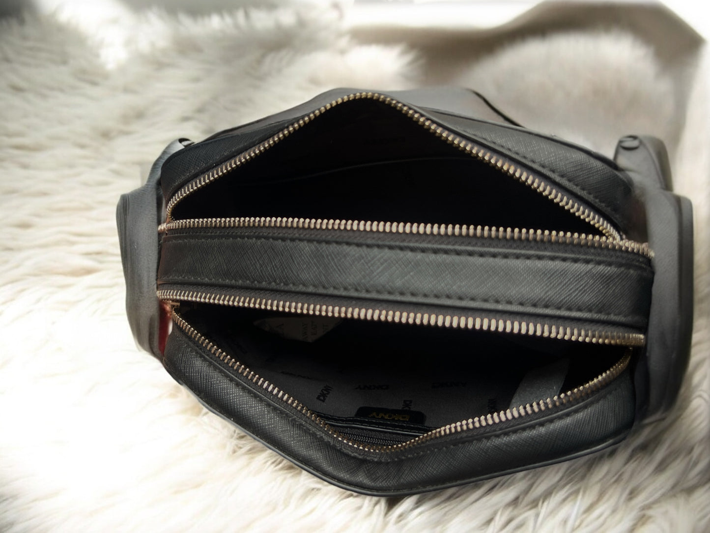 Crossbody DKNY negra con monogram blanco doble cierre