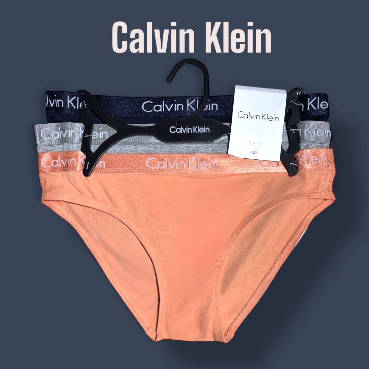 Panties Calvin k naranja, gris, azul marino y resorte brilloso con letras en blanco