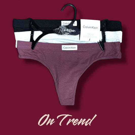 Tangas Calvin k morada, gris, negra, detalle en medio blanco con letras negras 3pzs