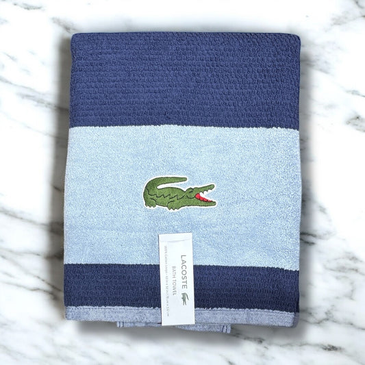 Toalla Lacoste azul marino, con línea gruesa en azul claro