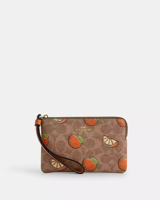 Muñequera Coach camel con mandarinas, monogram y strap naranja
