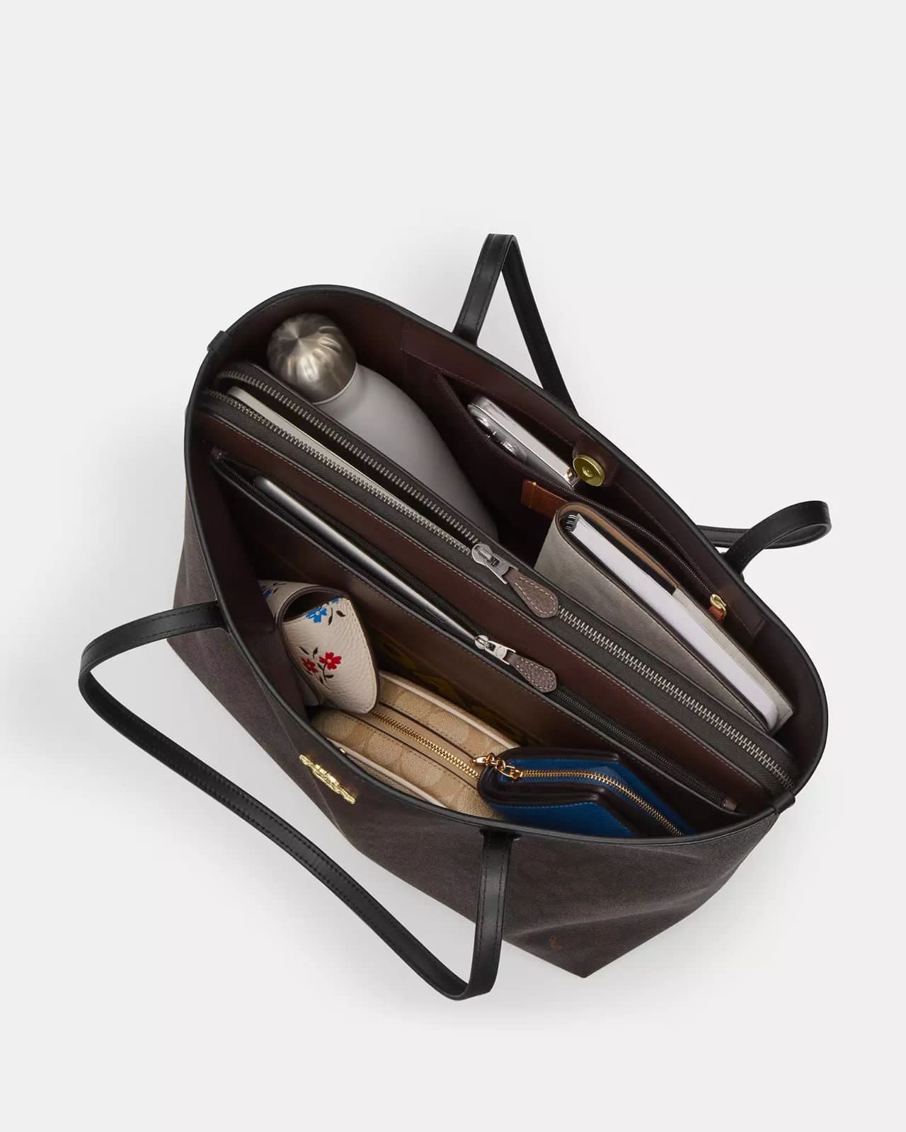 Tote Coach negra, grande con placa dorada