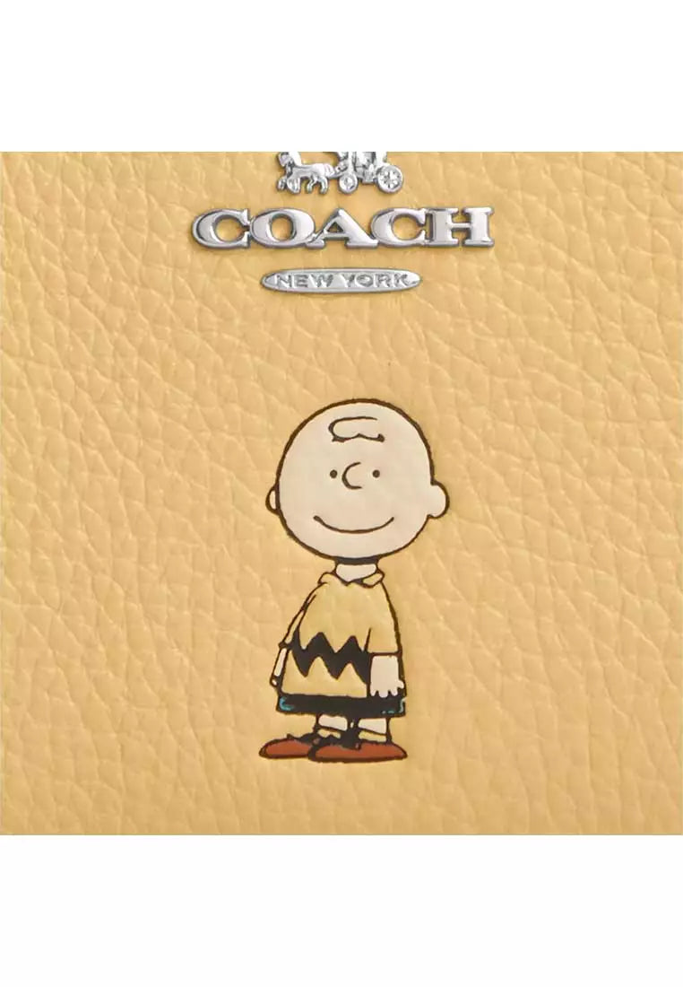 Cartera coach amarilla, Charly Brown