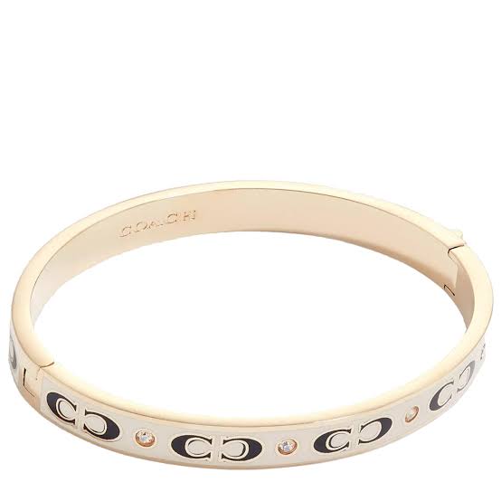 Brazalete Coach dorado/beige, letra negra