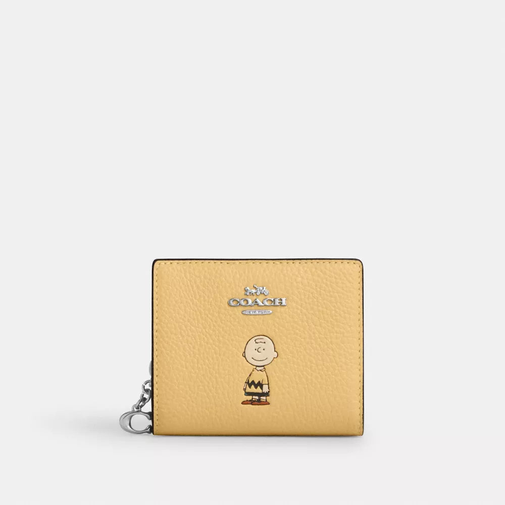 Cartera coach amarilla, Charly Brown