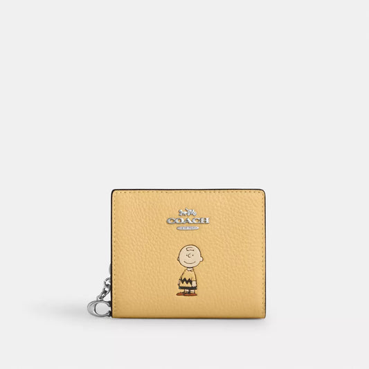 Cartera coach amarilla, Charly Brown