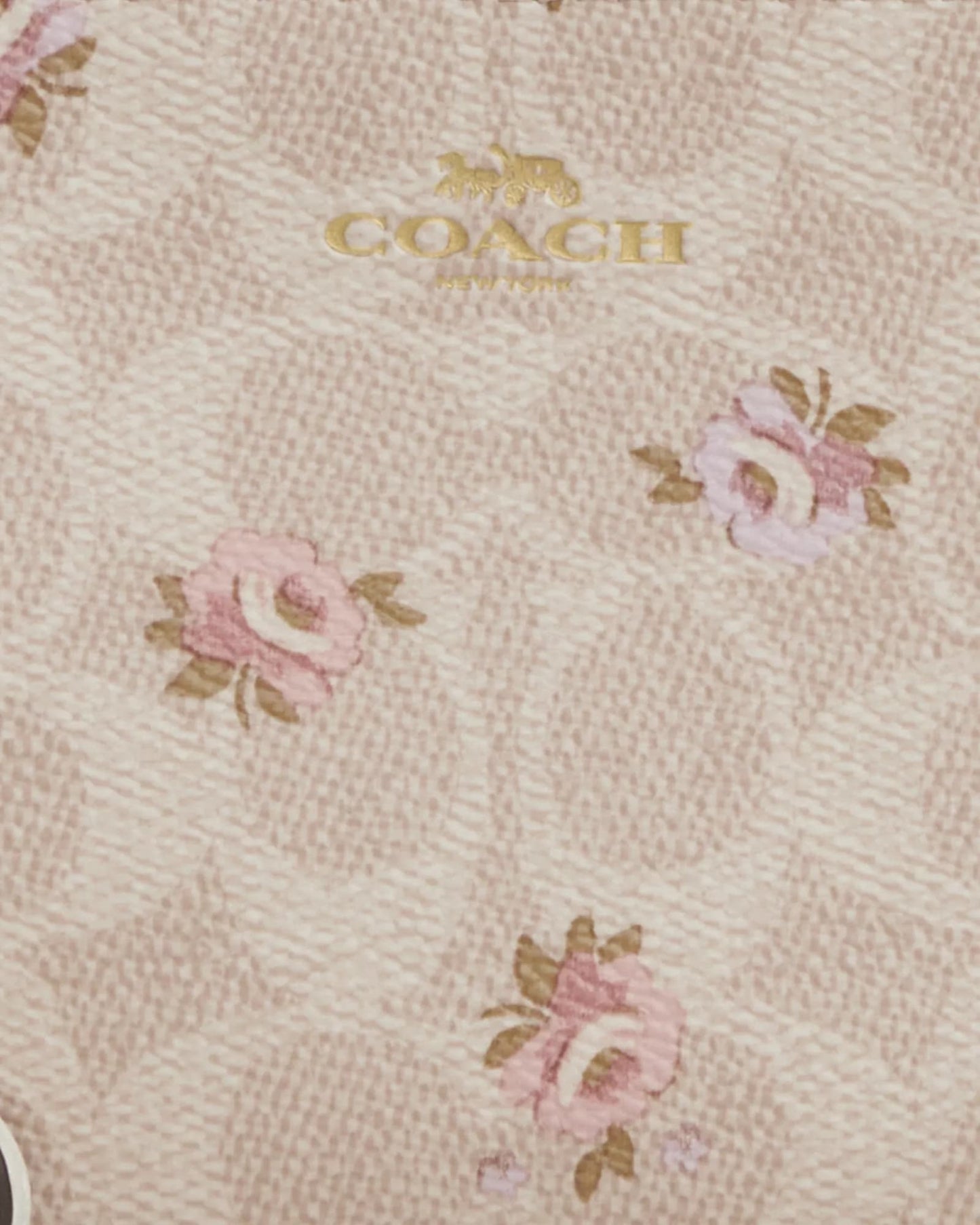 Muñequera Coach baige con monogram floreada y strap crema