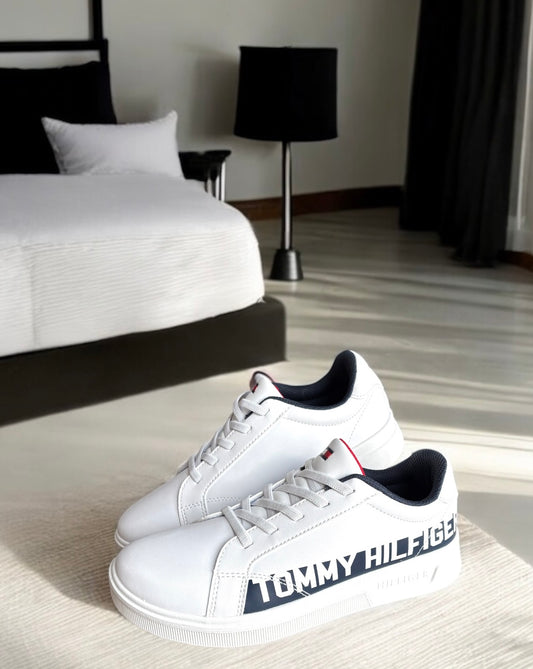 Tenis Tommy H blancos con letras blancas sobre línea azul marino