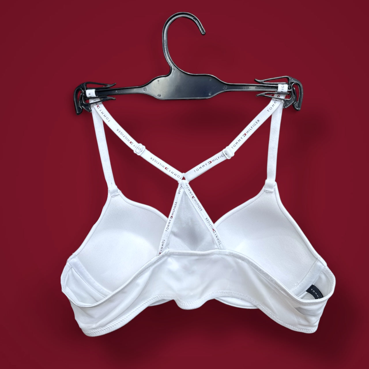Brasier TommyH blanco, strap cruzado y broche plateado enfrente