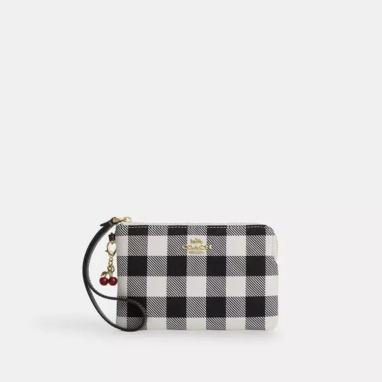 Muñequera Coach negra con blanco